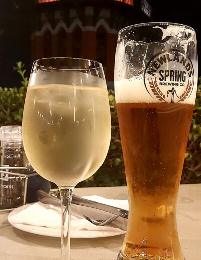a glass of wine and a pint of beer on a table