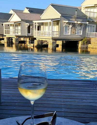 glass of wine on table at swimming pool